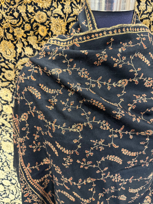 Black fabric with gold embroidery on a patterned background